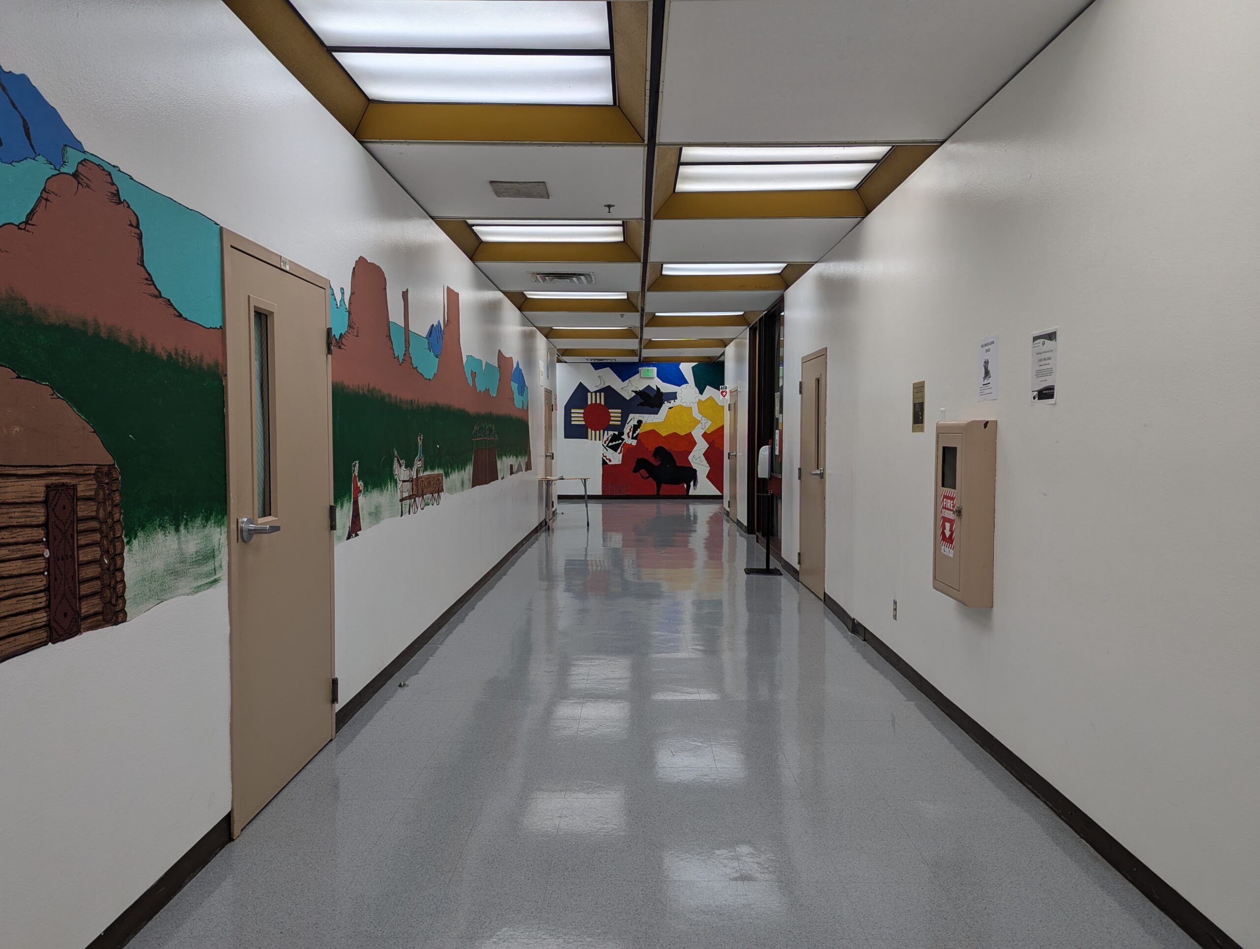 Hallways within the school building with student drawn murals